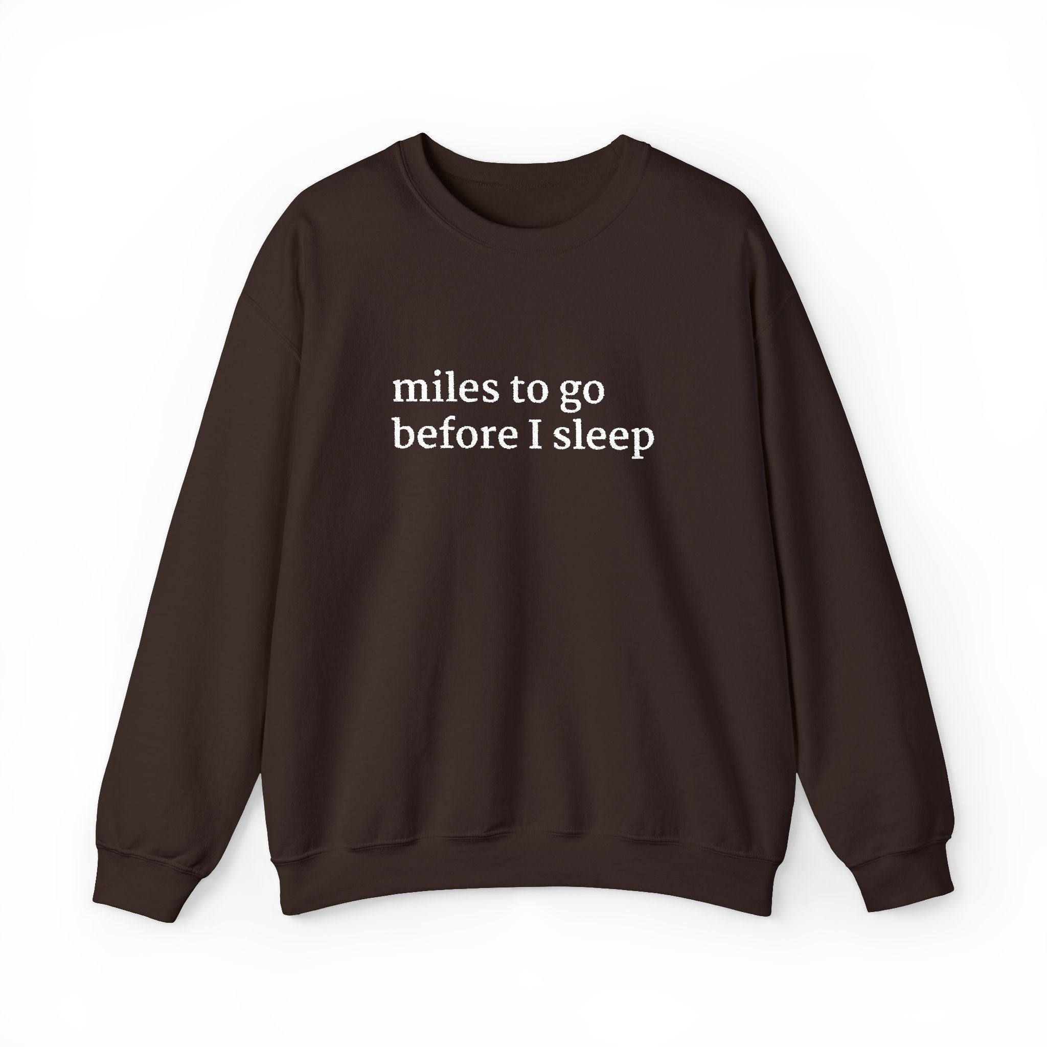 Chocolate brown crewneck sweatshirt with white embroidered text on the chest reading “miles to go before I sleep,” displayed on a plain white background.