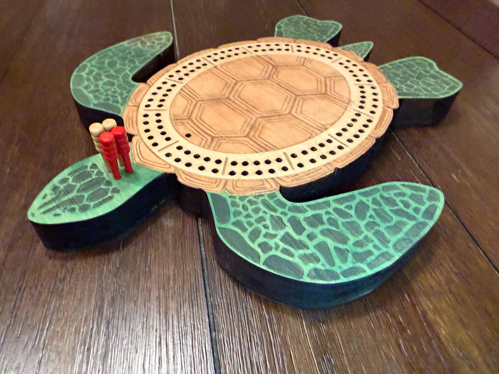 Tortoise-shaped cribbage board on a wooden surface