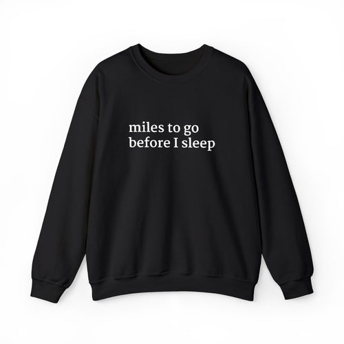 Black crewneck sweatshirt with white embroidered text on the chest reading “miles to go before I sleep,” displayed on a plain white background.