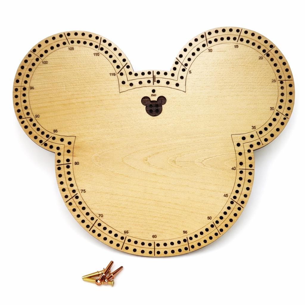 Handmade wooden mouse-shaped cribbage board with laser-engraved scoring tracks and numbered holes, shown on a white background with metal pegs included.